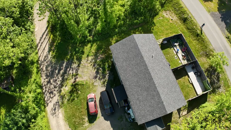 Elevated property view with trees and nearby homes