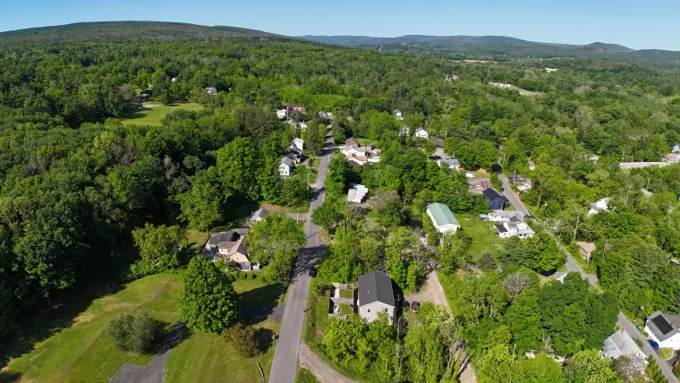 Drone view across Kerhonkson rooftops and wooded hills