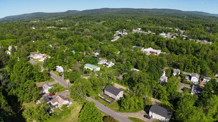 Wide aerial view of the property location and ridgeline setting